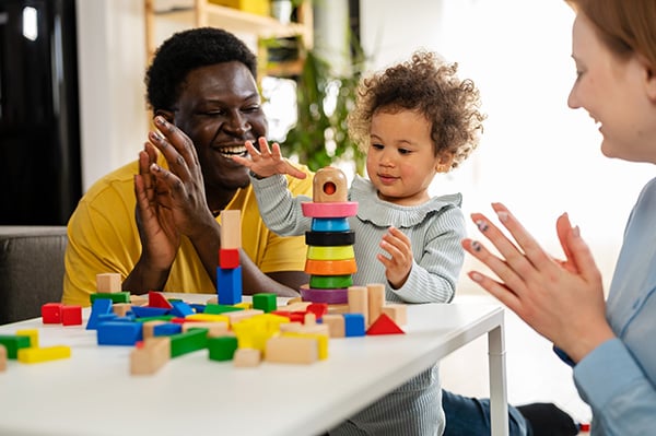 Family playing with stacking blocks